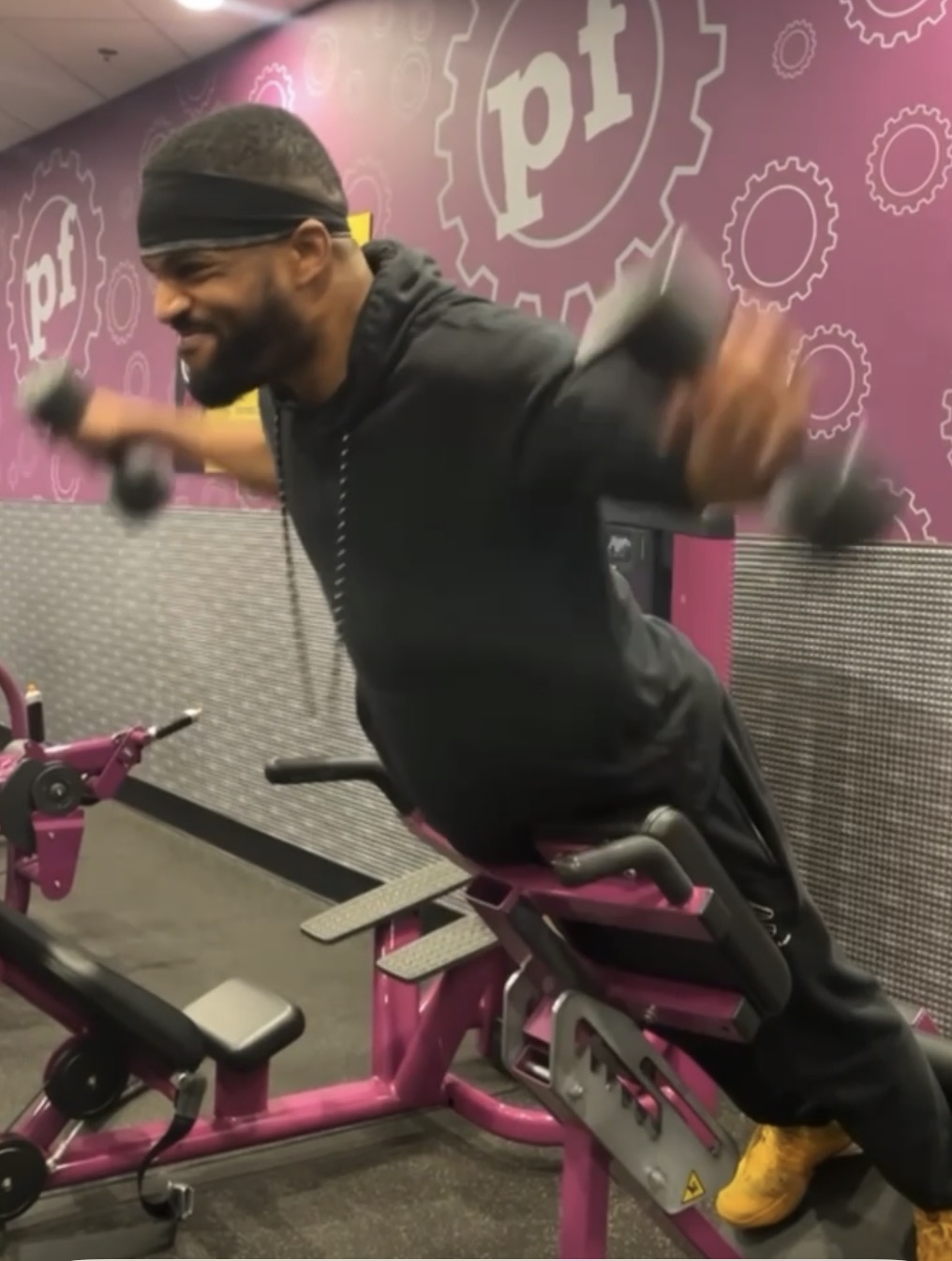 Coach Mike performing a strength exercise with dumbbells